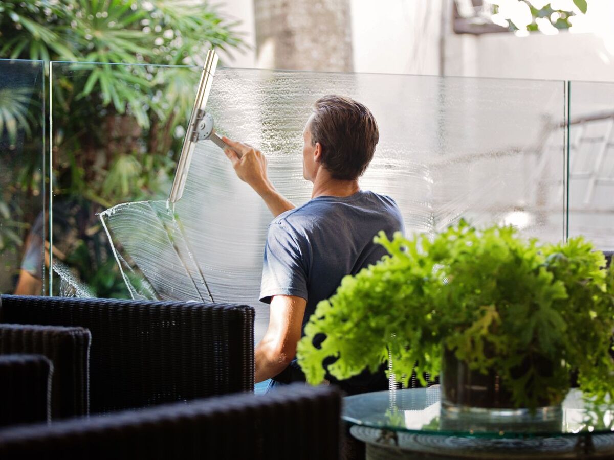 Cleaning an interior glass wall with a squeegee