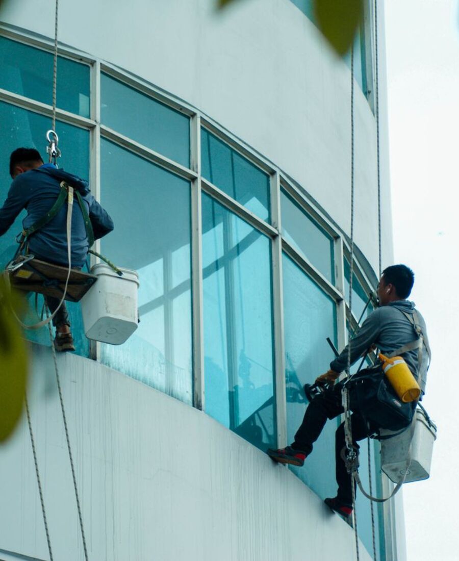 Window cleaners working on a curved office building