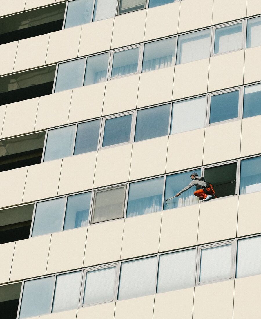 Apartment building with a window cleaner at work