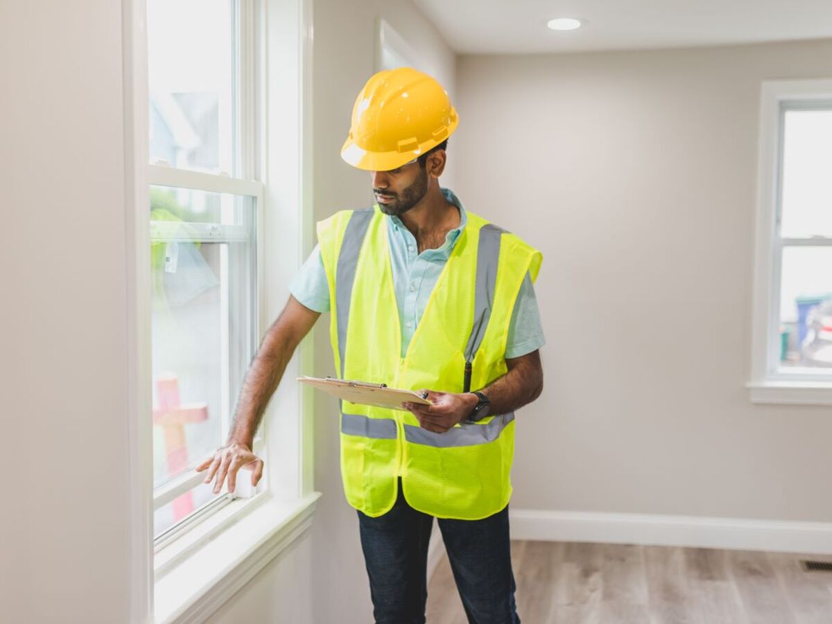 Shark Exterior crew member walking a commercial property with a clipboard