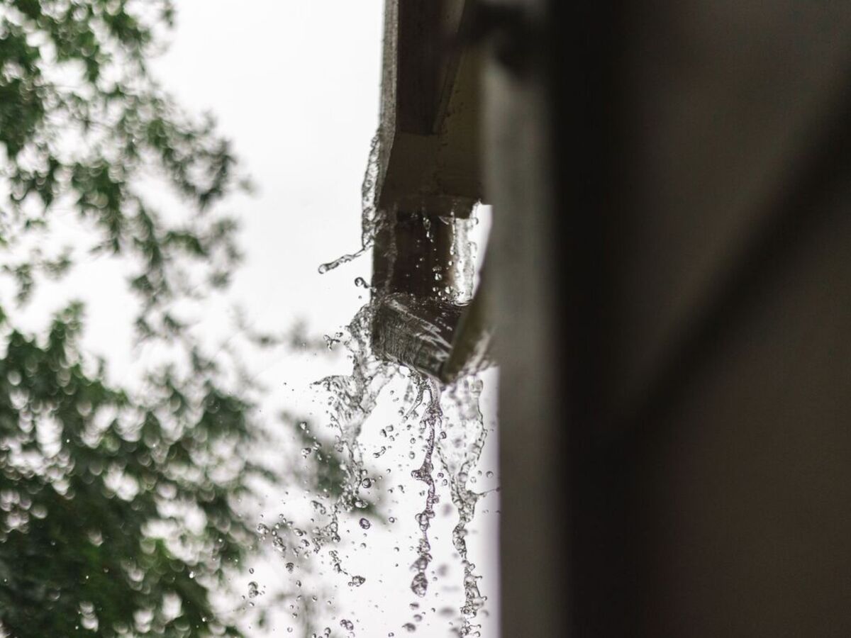 Rainwater running through a gutter and downspout