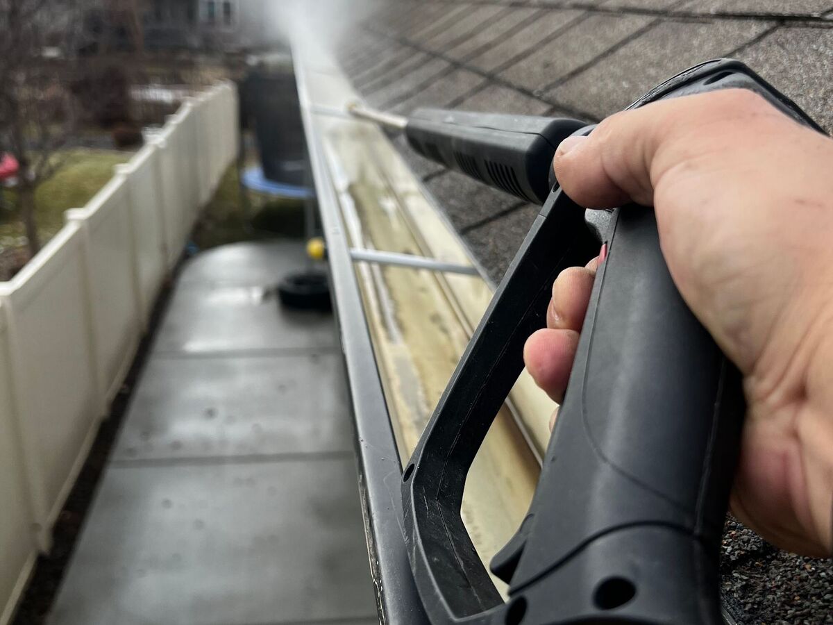 Flushing a residential gutter with water